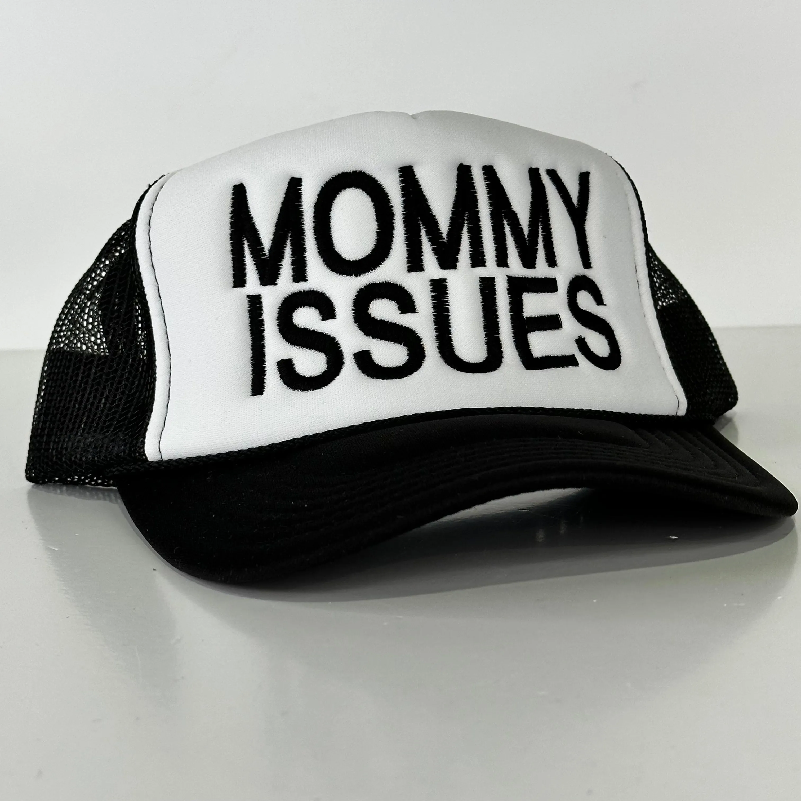 Mommy Issues on a black and white mesh trucker SnapBack cap hat custom embroidered